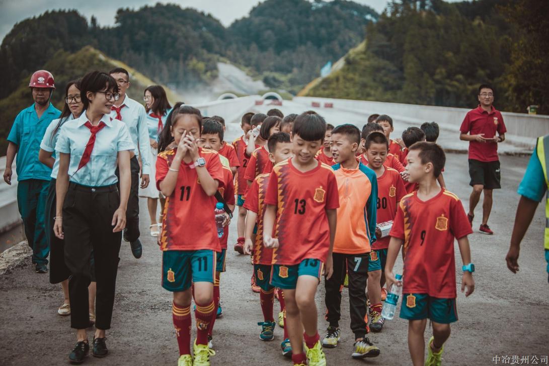 8月18日，由三施項目部定點幫扶的三穗一小足球隊22名小球員們，到三施高速項目進行參觀。在施工現場，小朋友們為建設者們戴上了表達敬意和謝意的紅領巾。（高凱）